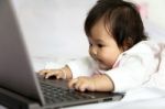 Baby Is Playing A Computer Stock Photo