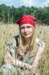 Blonde Dutch Teenage Girl Sitting In Cornfield Stock Photo