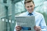 Handsome Businessman Reading A Newspaper Stock Photo