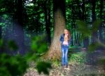 Frightened Little Girl In The Woods Stock Photo