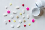 Top View Of The Pills On The White Background, The Drug And Capsule Pills On The Floor Stock Photo