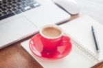 Red Coffee Cup With Notepad And Laptop Stock Photo