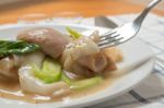 Rad Na, Famous Thai Chinese Style Wide Rice Noodle Dish With Tasty Tender Pork With Thick Gravy Sauce. Close Up With Fork Stock Photo