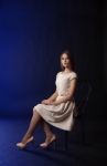 Young Girl Sitting On A Chair Stock Photo