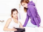 Happy Teenage Girls Using Touchpad Stock Photo