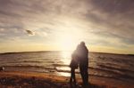 Couple On The Beach At The Sunset Stock Photo