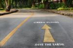 Words Of Save The Earth And Green Planet On The Road Surface Stock Photo