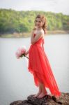 Beautiful Woman Wear Red Evening Dress Hold A Bouquet Of Flowers Stock Photo