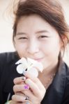 Asian Women Black Shirt. Holding White Flower Stock Photo