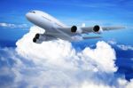 Airplane Flying In The Blue Sky Stock Photo