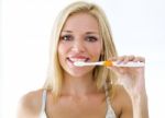 Pretty Young Blonde Woman Cleaning Her Teeth Stock Photo