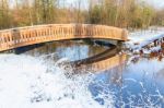 Wooden Bridge Snow And Water In Winter Season Stock Photo