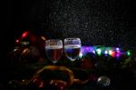 Two Glasses Of Champagne With A Christmas Decor In The Background Stock Photo