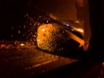 Rain Drops On The Side-view Mirror And Window Of A Car In The Raining Day Stock Photo