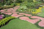 Garden With Red Paved Path Stock Photo