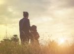 Mother And Daughter On Sunset Watching On Sky Stock Photo