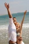 Young Couple Enjoying At Beach Stock Photo