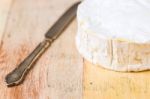 Camembert Cheese And Vintage Knife On Wooden Table Stock Photo