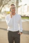 Man With Glasses Speak On Mobile Phone In Hands Stock Photo