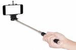 Hand Holding Phone Selfie Stick Isolated With Clipping Path Stock Photo