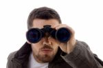 Male looking through binoculars Stock Photo