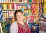 Smiling Woman In Front Of Corner Store In Small Town In Guatemal Stock Photo