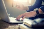 Close Up Of Young Businessman Working Typing On Laptop In Coffee Stock Photo