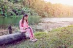 Young Girl Reading A Book In The Park Stock Photo