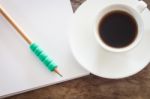 Pencil On Open Blank Notebook With Coffee Cup Stock Photo