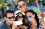 Portrait Of Group Friends Taking Photos With A Smartphone Stock Photo