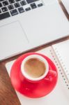 Red Coffee Cup With Notepad And Laptop Stock Photo