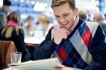 Stylish Man Reading Newspaper At Cafe Stock Photo