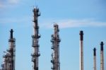 Distillation Towers And Smokestacks On Blue Sky Background Stock Photo