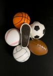 Foot Print On Shoe Among Balls In Black Background Stock Photo