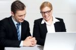 Colleagues Working Together On Laptop Stock Photo