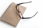 Blank Page Of A Notebook And Eyeglasses Stock Photo