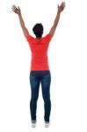 Back Pose Of A Woman With Raised Arms Stock Photo