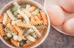 Fusili Pasta In Wooden Plate With Eggs Stock Photo