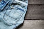 Jeans Lack On The Wooden Floor Stock Photo