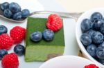 Green Tea Matcha Mousse Cake With Berries Stock Photo