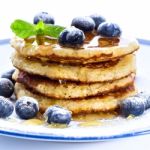 Pile Of Pancakes With Blueberries Sprinkled With Icing Sugar And Stock Photo