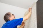 Elderly Worker Smoothing Wallpaper Stock Photo