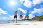 Happy Family Jumping On Beach In Thailand Stock Photo