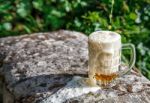 Glass Mug With Beer Standing On The Big Stone Stock Photo