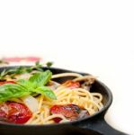 Spaghetti Pasta With Baked Cherry Tomatoes And Basil Stock Photo