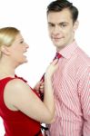 Lady Pulling Tie Her Husband Stock Photo