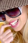 Smiling Lady Biting Nail Stock Photo