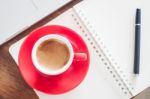 Red Coffee Cup With Notepad And Laptop Stock Photo