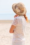 Woman Looking Into The Sea Stock Photo