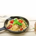 Spaghetti Pasta With Baked Cherry Tomatoes And Basil Stock Photo